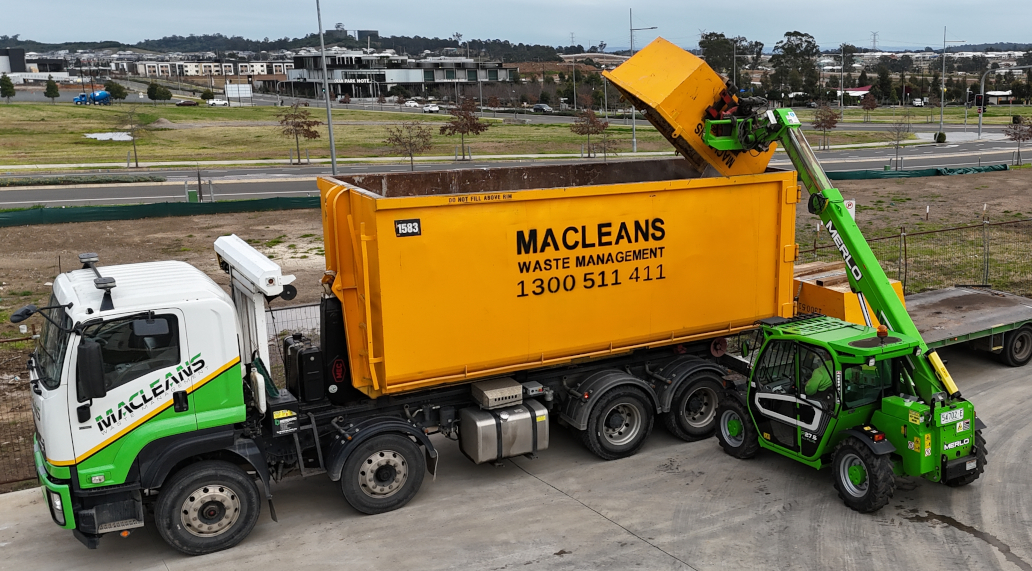 Macleans hooklift truck delivering a skip bin